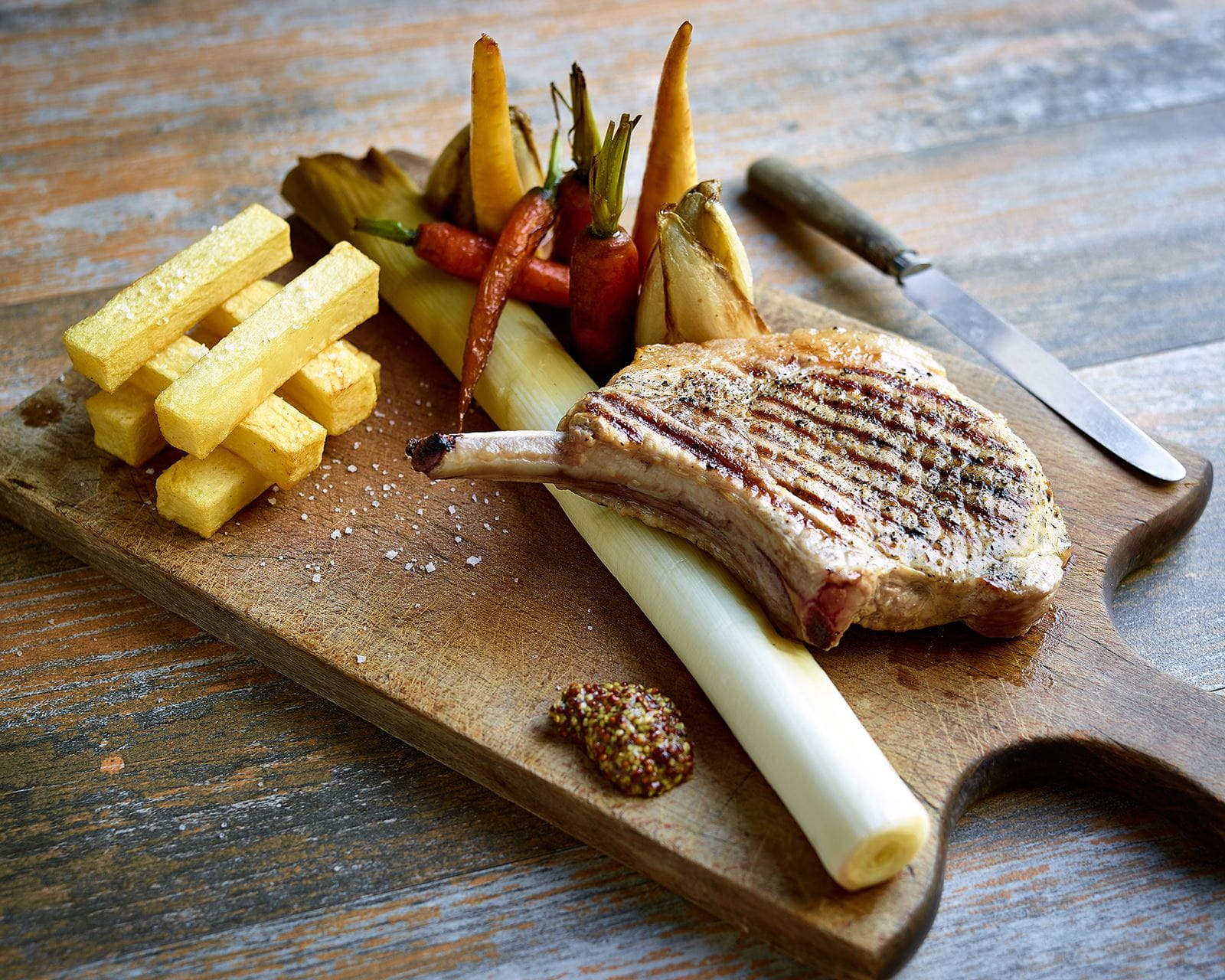 recipe image Varkenskroontje met Tierenteyn-mosterd en in honing geglaceerde seizoensgroenten